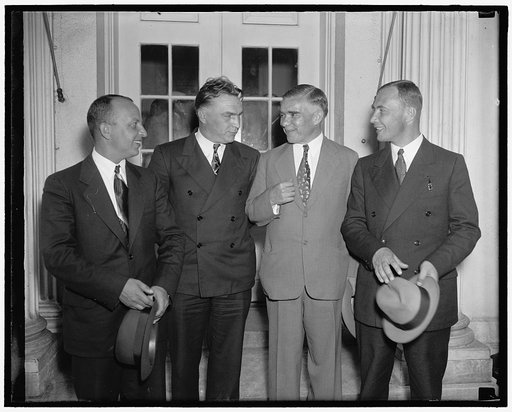 Soviet Flyers at White House. Washington D.C June 28. The three Soviet Flyer who conquered the North Pole route between the U.S.S.R. and the United States are shown leaving the White House today after being received by President Roosevelt. In the photograph, left to right: George Baiduckcv, co-pilot
