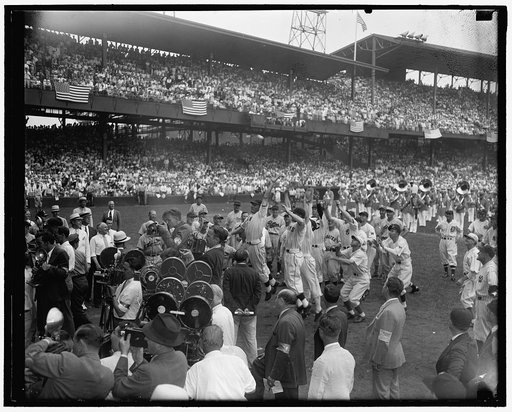 Scramble for Roosevelt pitch. Washington D.C., July 7. Risking millions of dollars of arms and limbs players from both All-Star teams stage a mad scramble to the first ball pitched by President Roosevelt to start the 1937 game today. Joe Moore, N.Y. Giants outfielder, caught the much coveted souveni
