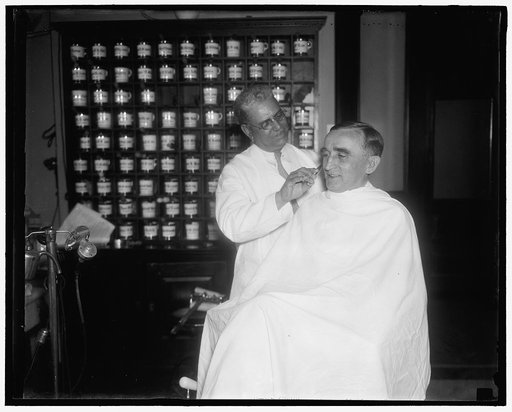 Just before the battle. Washington D.C., July 12. Senator Joseph C. O'Mahoney, [...]ing, gets a haircut and shave today in the barbershop before going on the Senate floor [...] the Administration Court Bill. [...] Leader Joseph T. Robinson, O'Mahoney charged responsibility for delay rests on the des