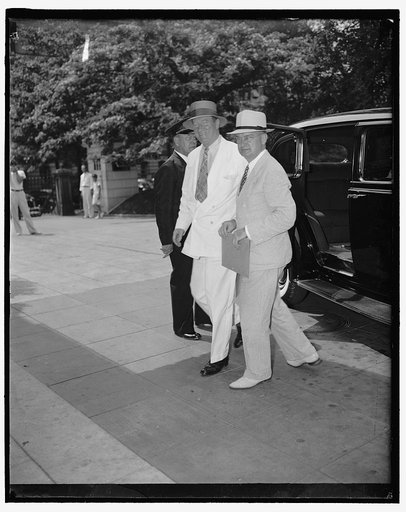 Arrive for White House conference. Washington D.C., July 14. Stewart McDonald, Federal Housing Administrator with J.M. Daiger (right) financial advisor to the Administrator arriving at the White House for the Housing Conference with the President, 7/14/37