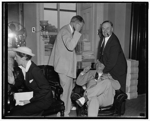 Senatorial horseplay. Washington D.C., July 22. Will you join us or not? Democratic Senators Burton K. Wheeler (left) and Edward R. Burke, (right) bitter opponents of the President's Court Reorganization Plan, engage in a bit of horseplay with Senator William H. Diedrich, Pro-Court Senator, as the a