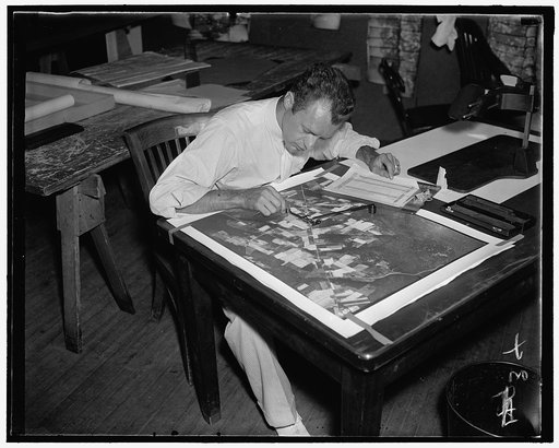 Working of $3,000,000 map. (2) C.E. Kowalozyk, AAA worker, using a planimetor, which measures the exact acreage in each section of land surface photographed, 7/28/37