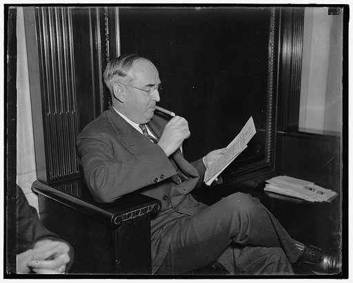 Withdraws amendments to labor relations law. Washington, D.C., July 30. Senator Arthur H. Vandenberg, Republican of Michigan, reads a copy of the Labor Relations Bill after withdrawing his amendments following a protest from William Green, President of the A.F.of L. Green charged that Vandenberg's a