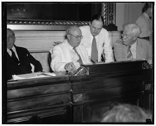 Big three of congressional tax hearing. Washington, D.C., Aug. 18. The income tax payers are not the only ones having headaches these days for the Senators and Treasury experts who are handling the congressional tax investigation are having theirs too. Here we see in a huddle, left to right: Senator
