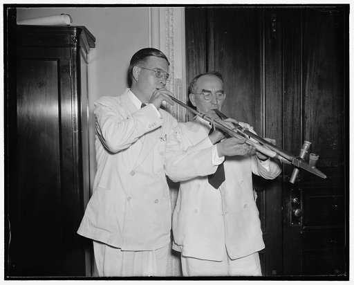 Politics forgotten. Washington D.C. Aug 21. Past political battles were forgotten tonight for Speaker Bankhead and Rep. Paul J. Kvale, Farmer-Labor Salon from Minnesota, when they joined in the pipe pf peace as the curtain on first session of 75th Congress was rung down. 8/21/37