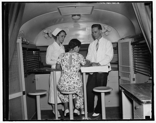 Trailer-laboratory is latest U.S. weapon in war against syphilis. Washington, D.C. Aug. 23. Dr. L.E. Burney and Nurse Fran Miller of the new trailer-laboratory which has just been completed for the United States Public Health Service, interview a "patient" as the trailer arrives in Washington for ex