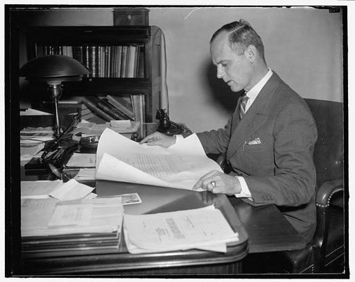 T.A.M. Craven, Chairman of the Federal Communications, looking over his new commission