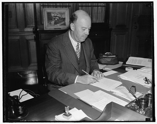 New Commissioner of Immigration. Washington, D.C., Aug. 26. James L. Houghsteling, of Chicago, photographed at his desk shortly after he took the oath of office as U.S. Commissioner of Immigration, 8/26/37