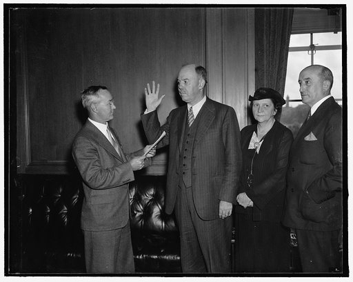 New U.S. Commissioner of immigration takes oath. Washington, D.C., Aug. 26. James L. Houghteling, newly appointed U.S. Commissioner of Immigration, today took the oath of office and assumed his duties. In the photograph, left to right: J.C. Watts, Assistant Chief Clerk of Labor Department, who admin