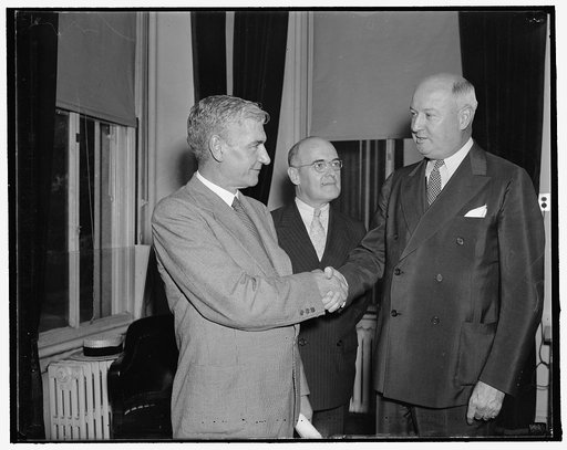 New register of the Treasury. Washington, D.C., Sept. 2. Dr. Edward G. Dolan of Manchester, Conn. took the oath of office today as register of the Treasury succeeding the late W.W. Durbin. He is congratulated by Stephen B. Gibbons, Asst. Sec. of the Treasury, Center, and Postmaster General James A. 