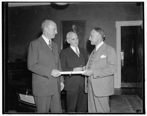 Gets new post in Bureau of Internal Revenue. Washington, D.C., Sept. 20. Secretary Henry Morgenthau presenting to John Philip Wenchel a commission as Assistant General Commission for the Bureau of Internal Revenue, succeeding Morrison Shafroth, resigned. Herman Oliphant, General Counsel for the Trea