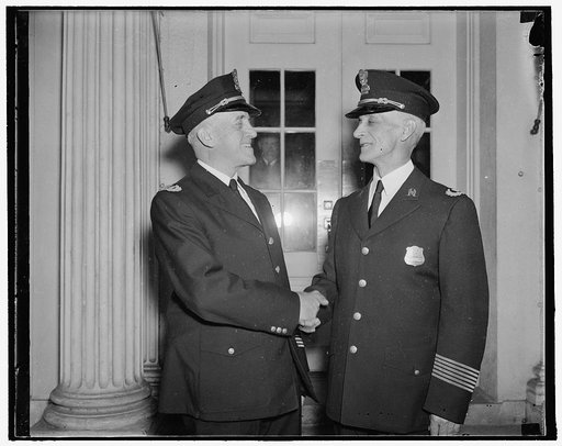 New White House Officer. Washington, D.C., Oct. 2. Captain Clarence L. Dalrymple, Chief of the White House police congratulating Liet. A.L. Walter, newly appointed Officer of the White House Force, Walter who has served at the White House for 20 years takes the place of Lieut. Larry Seaman recently 