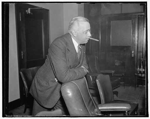Member of FCC. Washington, D.C., Oct. 7. Norman S. Case, member of the Federal Communications Commission, was snapped in this unconventional pose as he attended a meeting of the commission yesterday. 10/7/37