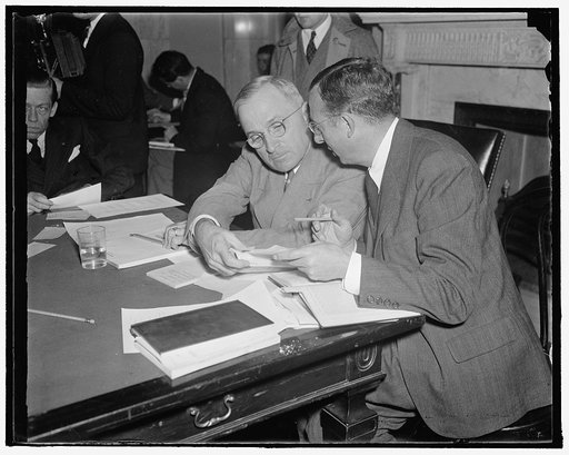 Heads in huddle as senate committee resumes railroad financing hearing. Washington, D.C., Oct. 20. Senator Harry S. Truman of Missouri, (left) acting Chairman, and Max Lowenthal, Counsel and Chief Investigator, go into a huddle as the Senate Committee investigating railroad financing resumed its ope