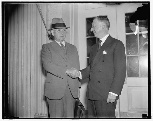 Congratulates new U.S. Housing chief. Washington, D.C., Oct. 20. Secretary Of Interior Harold Ickes (left) congratulates Nathan Straus, New York Housing expert, on his appointment as Head of the new U.S. Housing Administration. Straus will be responsible for carrying out provisions of the $526,000,0