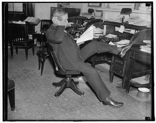 Last study of farm bill. Washington, D.C. Senator Ellison D. "Cotton Ed" Smith, Chairman of the Senate Agriculture Committee, makes a last- minute study of the newly drafted Farm Bill before introducing it on the floor of the Senate today. 11/22/37