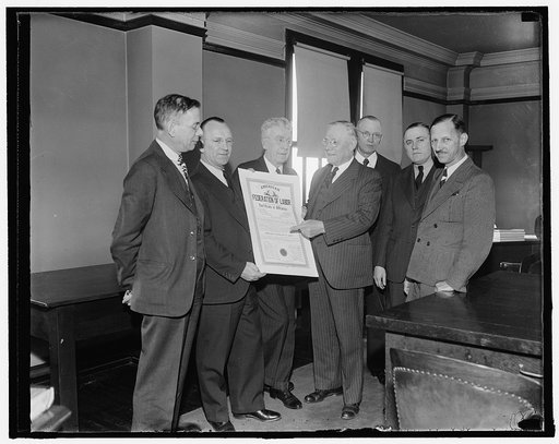 A.F. of L. charter granted to special delivery messengers. Washington, D.C., Nov. 23. A five-year effort to obtain a charter in the American Federation of Labor met with success today for the National Association of Special Delivery Messengers. A.F. of L. President William Green is shown presenting 
