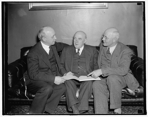 Co-authors discuss amendments to farm bill with Alabama senator. Washington, D.C., Nov. 30. Co-authors of the Senate Farm Bill, Senators George McGill of Kansas, (left) and Senator James P. Pope of Idaho, (right) discuss amendments to the bill now being written by Senator John B. Bankhead (center) o