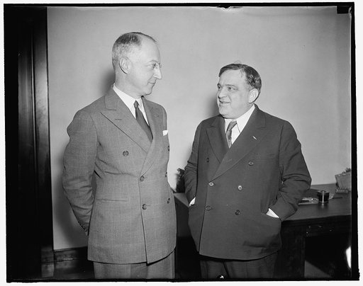 Meeting of New York's mayor and housing administrator ends in love feast. Washington, D.C., Dec. 11. What promised to be a red-hot meeting between U.S. Housing Administrator Nathan Straus (left) and New York Mayor Fiorella La Guardia took the form of a love feast before the confab ended. Straus said