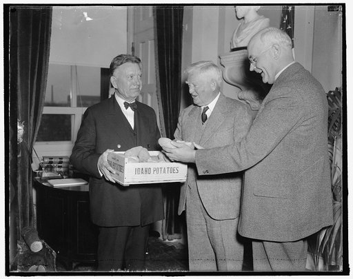 Idaho spuds presented to vice president. Washington, D.C., Dec. 6. A box of Idaho's choicest potatoes were presented today to Vice President John N. Garner by Senators William E. Borah, (left) and James P. Pope, both from the famous potato-growing state. The presentation was the signal for challenge