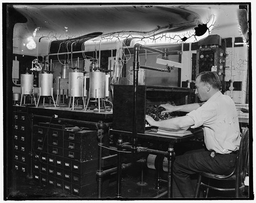 "Why is an Earthquake" Washington, D.C., Dec. 17. The old question "why is an earthquake," and many other geological mysteries important to man, are being probed by scientific gadgets such as the two pictured here at the Geological Laboratory of the Carnegie Institute. The scientists work and appara
