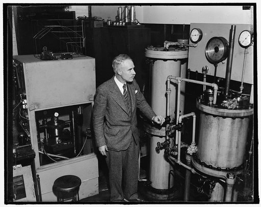Dangerous spot. Washington, D.C., Dec. 18. Dr. L.H. Adams, Director of the Geological Laboratory of the Carnegie Institution, is standing in what might be a dangerous position should the little steel drum in the cabinet [next to] him explode. In this apparatus the scientists study the behavior and p