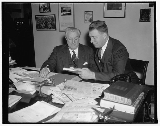 Fears airlines' bankruptcy. Washington, D.C., Dec. 20. Senator Edwin C. Johnson (right) of Colorado, today demanded prompt enactment of the McCarran Air Transport Bill in order to save America's commercial from bankruptcy and destruction. Studying the bill with the author Senator Pat McCarran, Senat