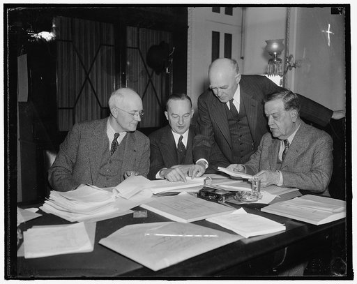 Congressional farm leaders compare notes. Washington, D.C., Jan. 5. Leading exponents of farm legislation in the House and Senate met at the Capitol today to compare notes on the progress made so far. Left to right: Senator James P. Pope of Idaho; Rep. Marvin Jones of Texas, Chairman of the House Ag