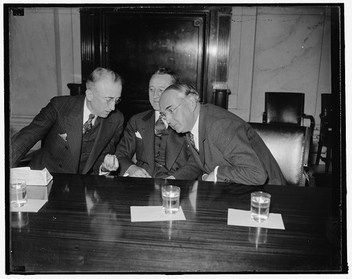 Last-minute huddle. Washington, D.C., Jan. 6. Members of the Special Senate Committee investigating unemployment, Senator Arthur Vandenberg, (left) Senator Carl A. Hatch, (center) and Senator James F. Byrnes, Chairman, go into a last-minute huddle before they called William S. Knudsen, President of 