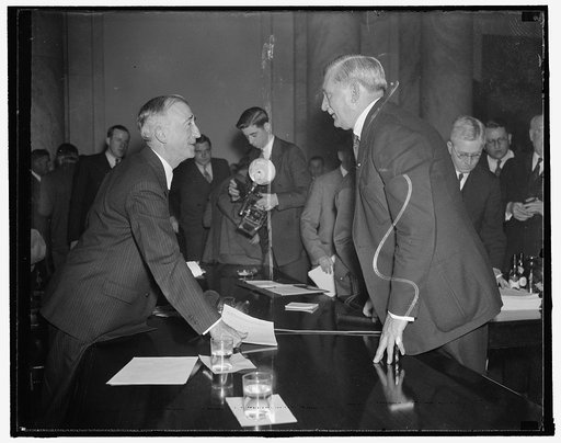 General Motors head arrives for questioning by senate committee. Washington, D.C., Jan. 6. Arriving to appear before the Special Senate Committee studying unemployment, William S. Knudsen, President of General Motors, is greeted by Sen. James F. Byrnes, Committee Chairman. Others in the pictures are
