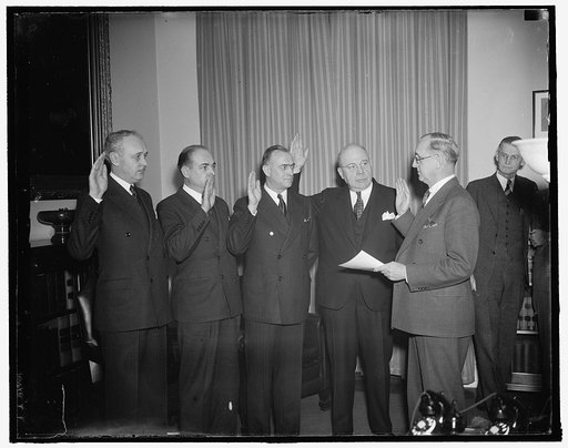 New Treasury appointees take oath. Washington, D.C., Jan. 15. Today was swearing-in day at the Treasury as four newly appointed Treasury aides took the oath of office. In the photograph, left to right: Goodwin J. Oppegard, to be Deputy Comptroller of the Currency; Gibbs Lyons, to be Chief National B