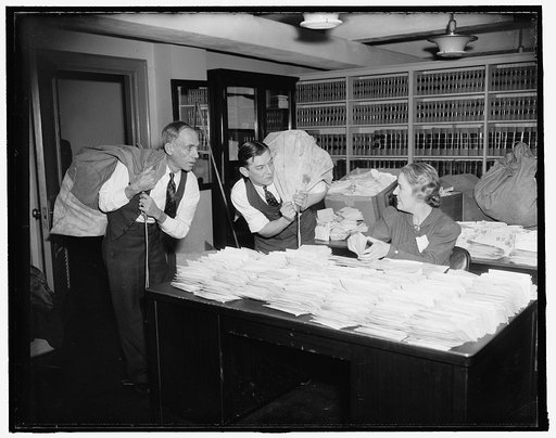 Huge task for Presidential Secretary. Washington, D.C., Jan. 28. The White House was virtually swamped today with letters containing 10-cent contributions to National Foundation for Infantile Pralysis. Miss Margaret Lehand, Personal Secretary to President Roosevelt, is shown as she began opening the