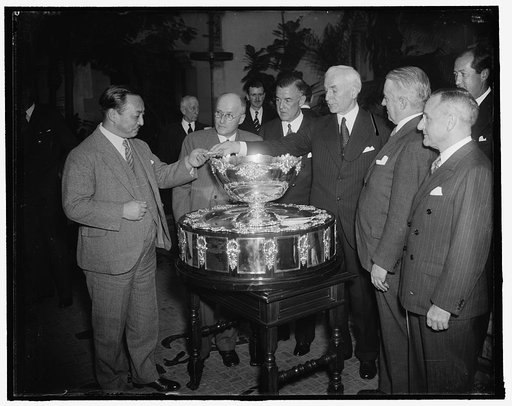 Secretary of State presides at Davis Cup drawing. Washington, D.C., Feb. 3. Presiding at the Davis Cup drawing at the Pan American Union today, Secretary of State Cordell Hull pulls Japan's pairing out of historic bowl first and hands it over to Yakichiro Suma, Counselor of the Japanese Embassy. In 