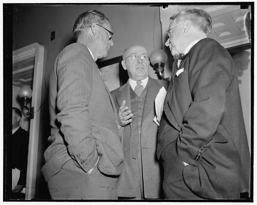 Maritime Commission head takes issue with Labor Secretary before senate. Washington, D.C., Feb. 16. Joseph P. Kennedy, (left) Chairman of the U.S. Maritime Commission, engages in an "off-the-record" talk with Senator Royal S. Copeland, (right) Chairman, and Senator Elbert D. Thomas, a member of the 