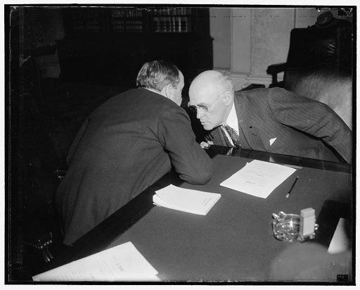 Senatorial huddle. Washington, D.C., Feb. 24. Like Moslems in prayer these two Senators, Robert J. Bulkley of Ohio, and John H. Bankhead, of Alabama, huddled during a lull at Senate Banking and Currency Subcommittee on the Bulkley Bill providing for $6,000,000,000 system of superhighways in the U.S.