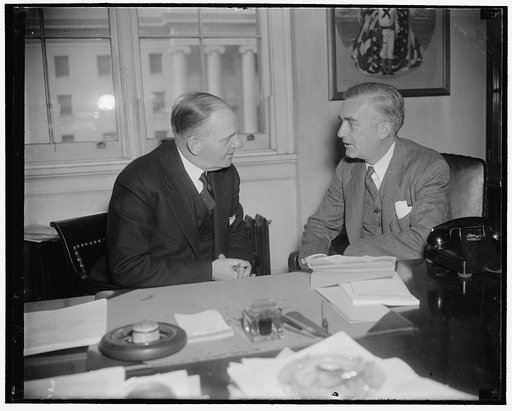 A Navy so strong other nations won't risk war with U.S., Edison tells house committee. Washington, D.C., Feb. 26. Rep. Carl Vinson, (left) Chairman of the House Naval Affairs Committee, chats with Assistant Secretary of the Navy Charles Edison just before he (Edison) appeared before the committee to