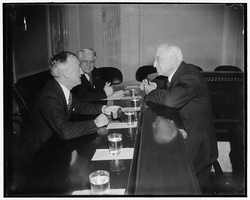 Baruch quizzed by Senate Committee. Washington, D.C., Feb. 28. Senator James F. Byrnes, (left) Chairman of the Senate Unemployment and Relief Committee, questioning Bernard Baruch, voted Financier today. Baruch declared America must make a choice between the "proof of its system and the hope of gain