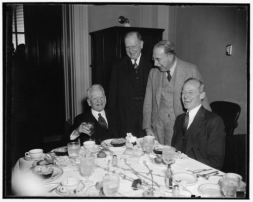 Veteran Virginia Senator. Washington, D.C., March 9. Senator Carter Glass, left, veteran legislator from Virginia, seemed to be in a happy frame of mind while having luncheon in the senate restaurant today. He is an expert on monetary matter, 3/9/38