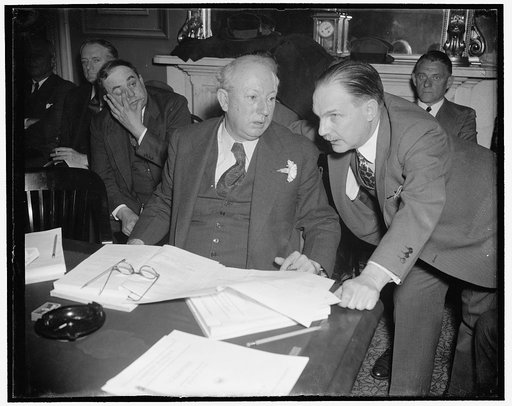 Senate Finance Chairman and Treasury expert go into last minute huddle. Washington, D.C., March 17. Senate Finance Committee [...] Pat Harrison, (left) went into a last-[minute] conference with Lovell H. Parker, Treasury [...] , just before the Committee held its first [...] hearing today. Parker wa