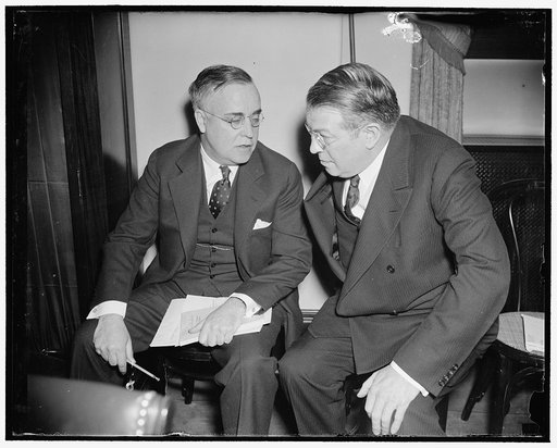 In spotlight at Senate Lobby Committee. Washington, D.C., March 18. Dr. Edward A. Rumely (right) Executive Secretary of the Committee to uphold constitutional government, who today defied a Senate subpoena when he refused to turn over the files of his organization to the Senate Lobby Committee, is s