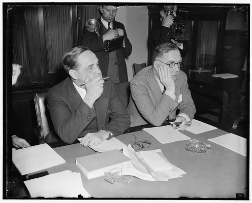 Guiding Senate Lobby investigation. Washington, D.C., March 18. All eyes are now focused on the Senate Lobby Committee hearing as questioning of the country's leading lobbyists began today. Chairman Sherman Minton (left) is directing the investigation with Senator Lewis Schwellenback, Committee memb