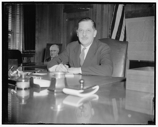 Assumes post as Assistant Attorney General. Washington, D.C., March 21. Thurman Arnold, former Yale University Law Professor, photographed at his desk today shortly after taking the oas as Assistant Attorney General, succeeding Robert H. Jackson, 3/21/38