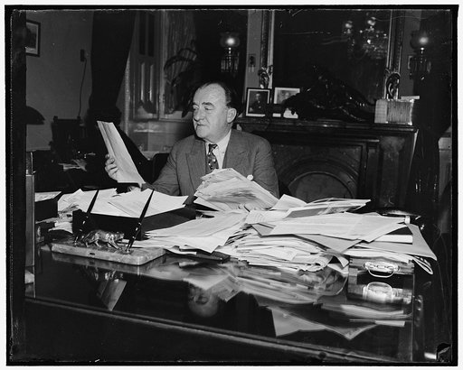 Swamped with protests against reorganization bill. Washington, D.C., April 2. Chairman of the House Rules Committee, Rep. John J. O'Conner of New York, was virtually swamped today with telegraphic protests against the Reorganization Bill. He is shown reading a few of the requests during a respite fr