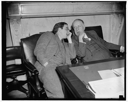 Veteran and rookie. Washington, D.C., April 8. Youth and age exchange comments on witnesses before the Senate Naval Affairs Committee open hearing on the $1,121,000,000 Naval Expansion bill. Pictured are Senator Rush D. Holt, member of the committee, and Senator David I. Walsh (right) Committee Chai