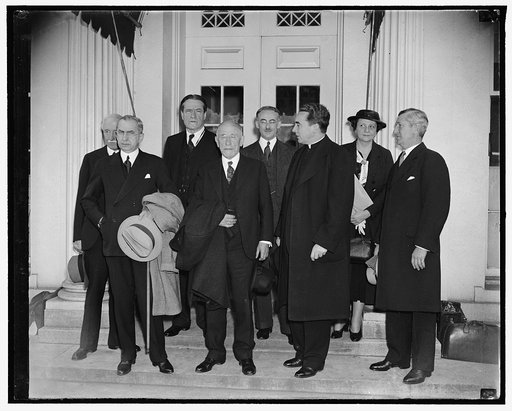Aid to refugees planned at White House. Washington, D.C., April 13. Experts on the refugee problem shown leaving the White House today after conferring with President Roosevelt, the group met with the President to go over preliminaries to an international conference to help political refugees form G
