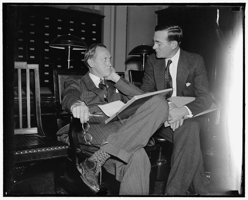 Last minute huddle. Washington, D.C., April 20. Loaded down with facts and figures on President Roosevelt's $4,512,000,000 Recovery Drive, WPA Administrator Harry Hopkins (left) and his First Assistant Chief Aubrey Williams, await the opening of The House Appropriations Committee Hearing today where