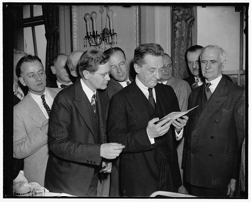 20-Year signature interests Kerensky. Washington, D.C., April 21. Following a talk to members of the National Press Club today, Alexander Kerensky, Head of the Russian Provisional Government of 1917, is shown a passport issued and signed by him to D. Heywood Hardy (left), Washington attorney who ser