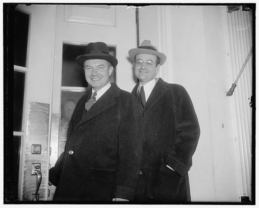 Confer with president. Washington, D.C., Jan 24. Robert H. Jackson (left) Assistant Attorney General, and Ben Cohen Office of the President's "Braintrusters", leaving the White House today after a conference with President Roosevelt. It is believed they discussed projected anti-monopoly recommendati