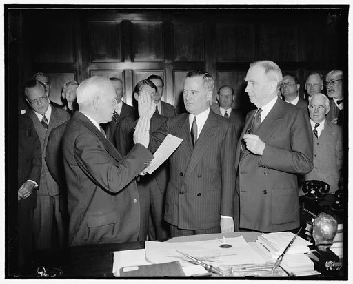 New Assistant Secretary of Commerce takes oath. Washington, D.C., May 13. Col. Richard C. Patterson, Jr., is pictured as he was sworn in today as Assistant Secretary of Commerce by E.W. Libby, Chief Clerk of the Dept. of Commerce. Col. Patterson succeeds Ernest Draper, who named a member of the Fede