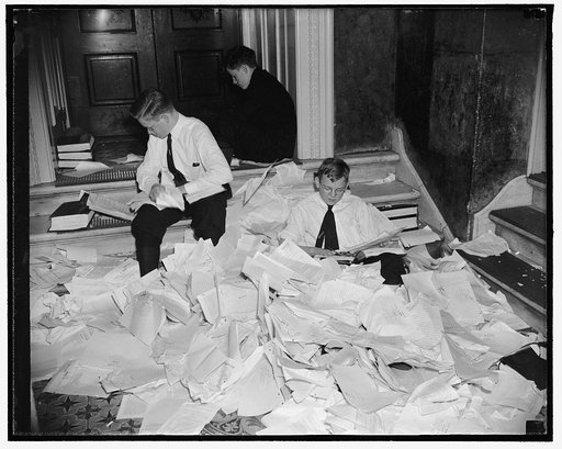 It won't be long now! Washington, D.C., May 19. Early adjournment of the Senate was forseen today by the number of bills being rapidly passed. Senate pages are pictured tearing from calender, bills that were passed yesterday, 5/19/38